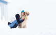 Photo: Girl in winter suit on a walk with her labrador. Girl in winter Girl in winter suit on a walk with her labrador. Girl in winter