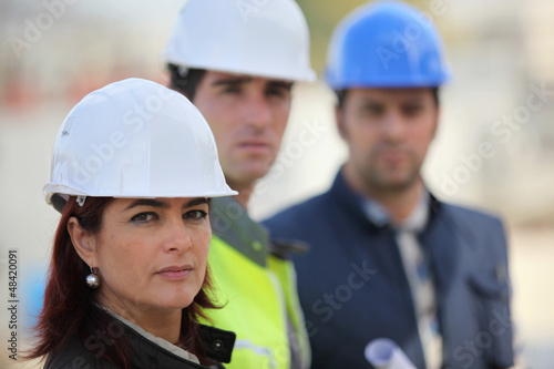 Photo: Three architect colleagues at construction site Three architect colleagues at construction site