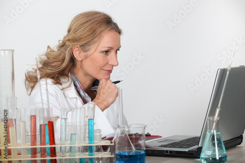 Photo: Blond researcher in lab using laptop computer Blond researcher in lab using laptop computer
