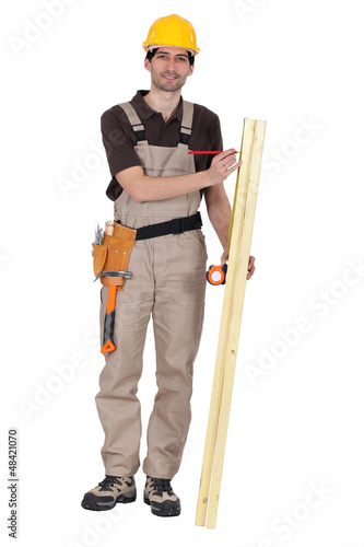 Photo: Man measuring wood Man measuring wood