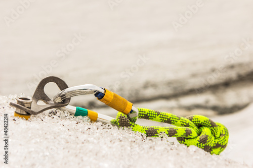 Photo: Carbine and hook with rope in ice. Carbine and hook with rope in ice.