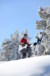 Man stood at the top of mountain with snowboard
