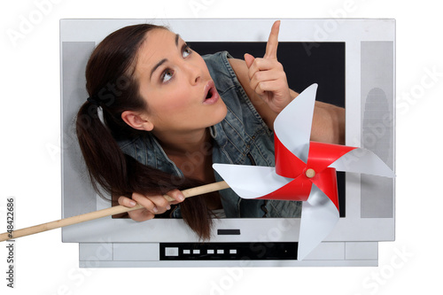 Photo: Woman escaping from television screen Woman escaping from television screen