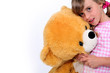 Little girl hugging a teddy bear