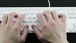 Typing on the white laptop Keyboard