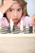 little girl playing chess