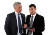 Two businessmen interacting on white background