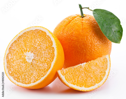 Photo: Orange with leaf on a white background. Orange with leaf on a white background.