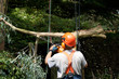 Trimming branches with chainsaw