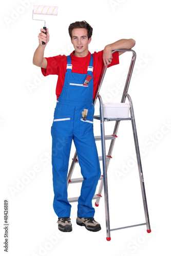 Photo: Decorator with a paint roller and stepladder Decorator with a paint roller and stepladder