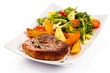 Grilled steak, baked potatoes and vegetables