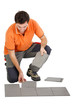 Man laying out tiles on the floor