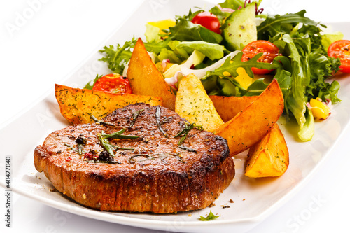 Photo: Grilled steak, baked potatoes and vegetables Grilled steak, baked potatoes and vegetables