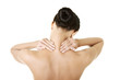 Naked young woman holding hands on neck in back pain.