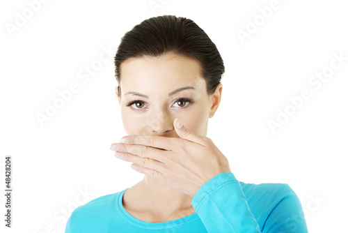 Photo: Woman covering mouth with hand Woman covering mouth with hand