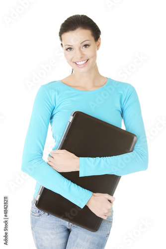 Photo: Young woman holding 17 inch laptop Young woman holding 17 inch laptop