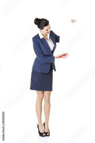 Photo: Attractive businesswoman holding blank board Attractive businesswoman holding blank board