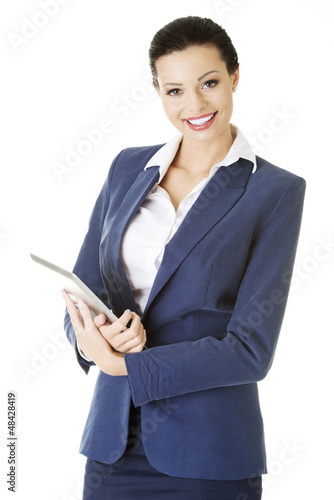 Photo: Attractive businesswoman using tablet computer Attractive businesswoman using tablet computer
