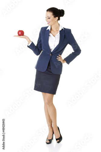 Photo: Attractive businesswoman holding red apple Attractive businesswoman holding red apple