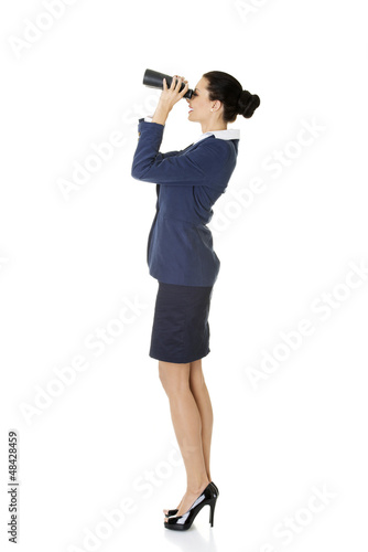 Photo: Businesswoman with binoculars. Businesswoman with binoculars.