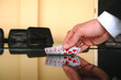 Businessman holding playing cards