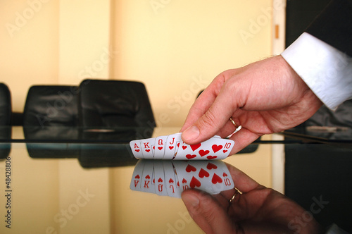 Photo: Businessman holding playing cards Businessman holding playing cards