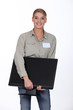 Woman delivering computer monitor