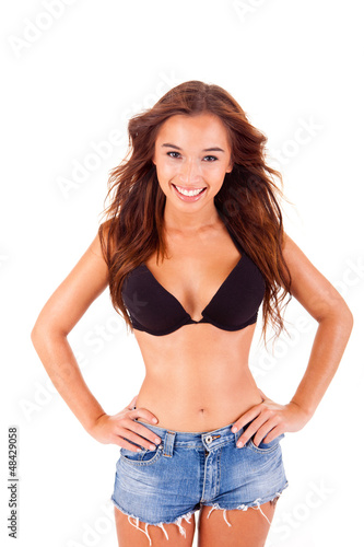 Photo: Beautiful young woman dressing bikini and shorts Beautiful young woman dressing bikini and shorts