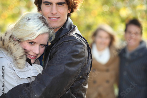 Photo: Two couple walking in park Two couple walking in park