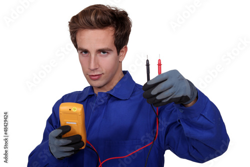 Photo: an electrician using an ammeter an electrician using an ammeter