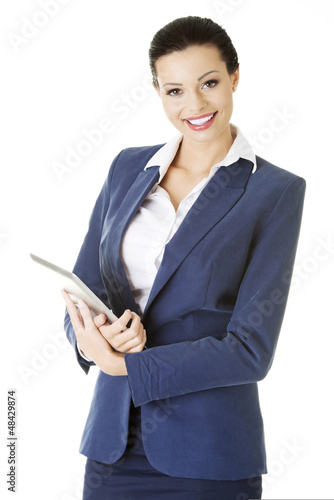 Photo: Attractive businesswoman using tablet computer Attractive businesswoman using tablet computer