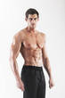 Photo: Muscled male model posing in studio Muscled male model posing in studio