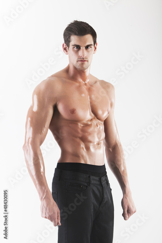 Photo: Muscled male model posing in studio Muscled male model posing in studio
