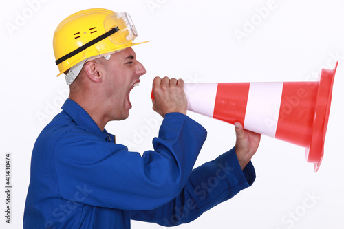 Photo: Tradesman screaming into a pylon Tradesman screaming into a pylon