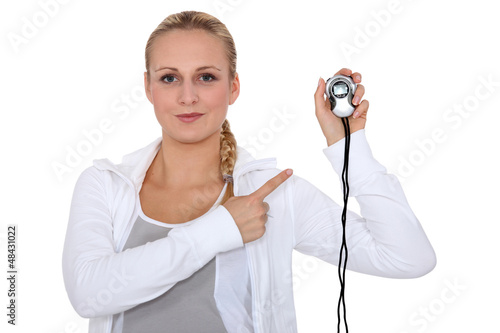Photo: a blonde woman in sports suite showing a chronometer a blonde woman in sports suite showing a chronometer
