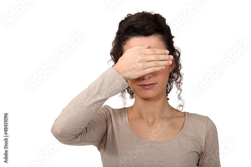 Photo: Woman covering eyes Woman covering eyes