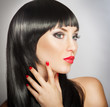 Photo: Woman with bright red lips and manicure, black hair Woman with bright red lips and manicure, black hair