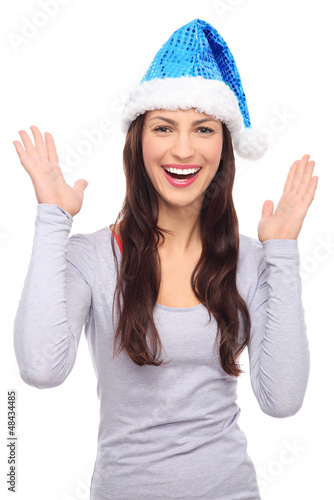 Photo: Woman in Santa hat gesturing Woman in Santa hat gesturing