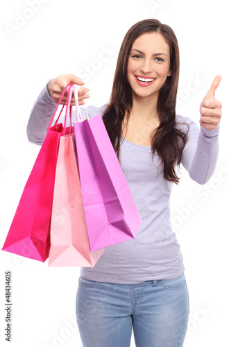Photo: Woman with shopping bags and thumbs up Woman with shopping bags and thumbs up