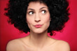 Woman with afro wig looking to the side
