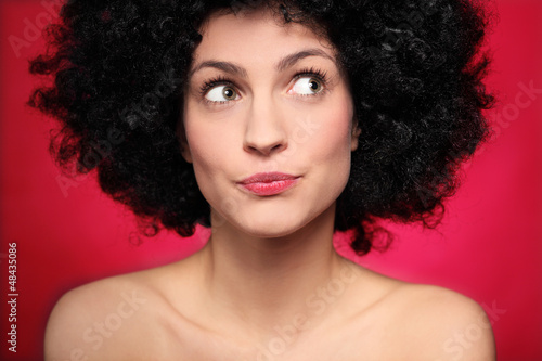 Photo: Woman with afro wig looking to the side Woman with afro wig looking to the side