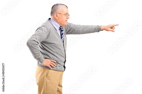 Photo: Angry mature man pointing with finger Angry mature man pointing with finger