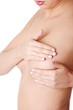 Woman examining breast mastopathy or cancer.