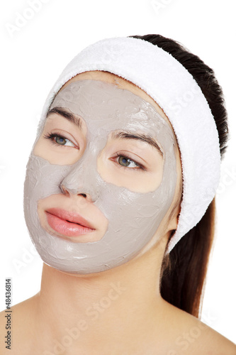 Photo: Beautiful woman with clay facial mask Beautiful woman with clay facial mask