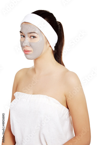 Photo: Beautiful woman with clay facial mask Beautiful woman with clay facial mask
