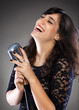 Photo: Attractive young woman with a retro microphone Attractive young woman with a retro microphone
