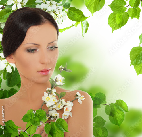 Photo: Beautiful young woman with spring blossom Beautiful young woman with spring blossom