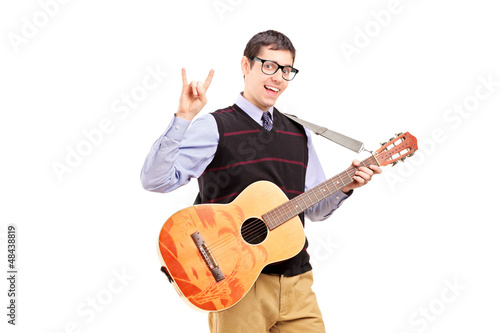 Photo: Man with a guitar making a rock and roll hand sign Man with a guitar making a rock and roll hand sign