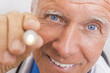 Senior Male Doctor With Pen Light