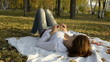 The young woman turned on bedspread in autumn park